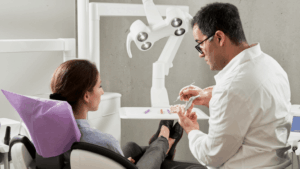 dentist discussing with patient in dental chair